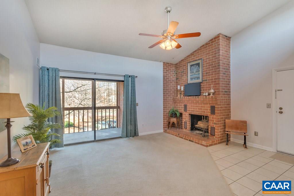 101 Turtle Creek Road, Unit 12 Charlottesville, VA 22901 - Photo 5 of 36 a view of an empty room with a fireplace and a window