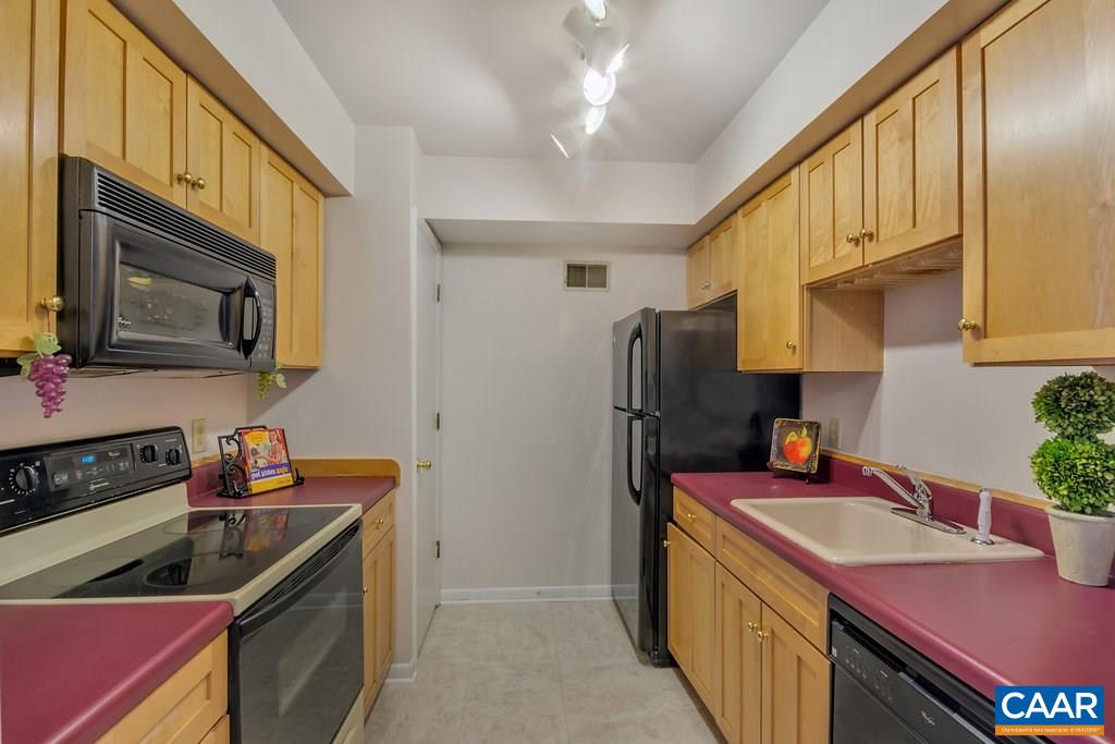 101 Turtle Creek Road, Unit 12 Charlottesville, VA 22901 - Photo 7 of 36 a kitchen with stainless steel appliances a sink stove refrigerator and cabinets