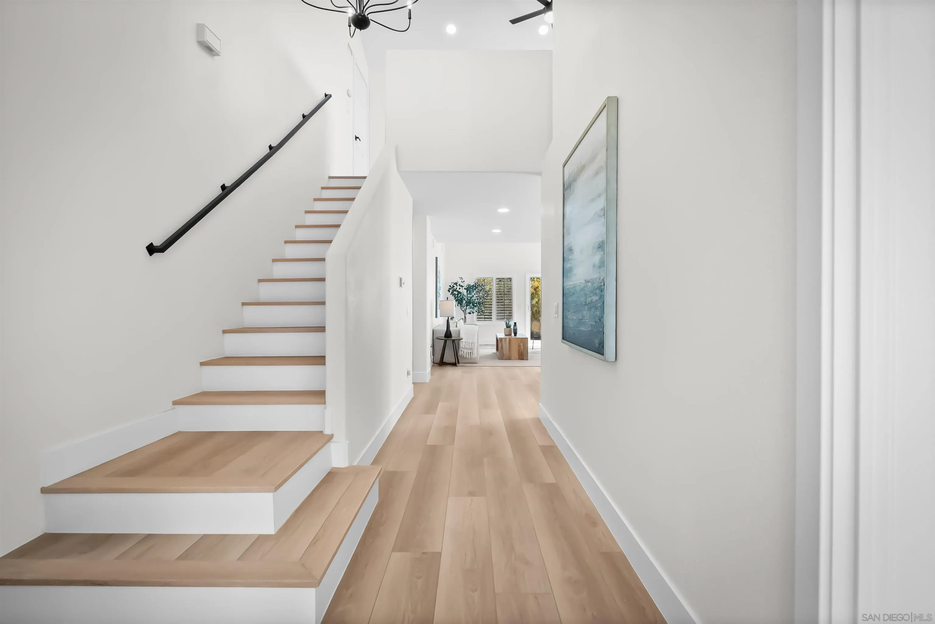 4058 Lemnos Way Oceanside, CA 92056 - Photo 11 of 47 a view of a hallway with wooden floor and staircase