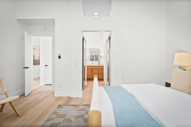 a bedroom with a bed and a mirror