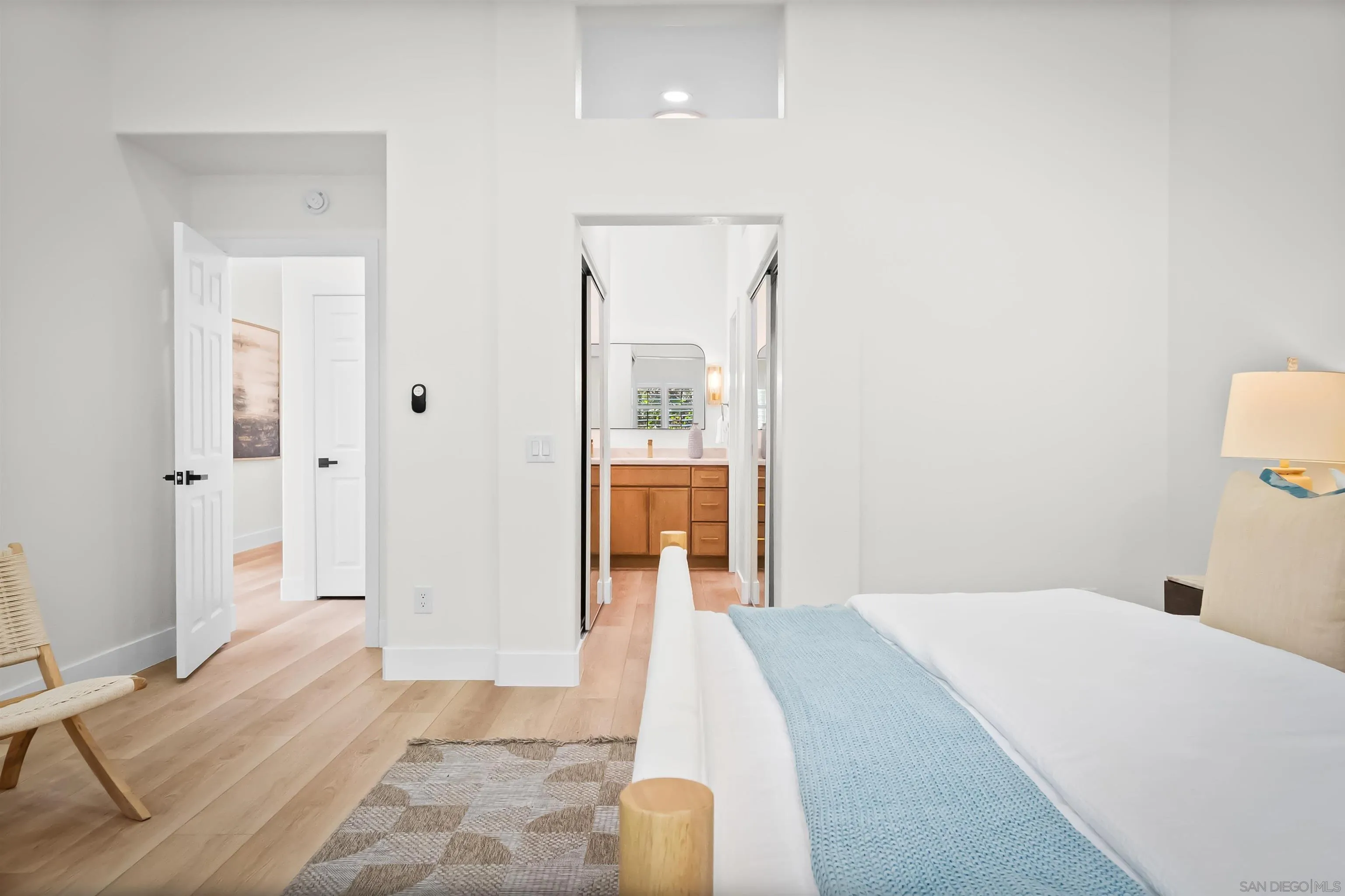 4058 Lemnos Way Oceanside, CA 92056 - Photo 19 of 47 a bedroom with a bed and a mirror