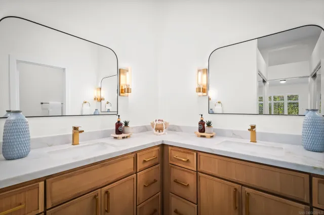 a kitchen with a sink and a mirror