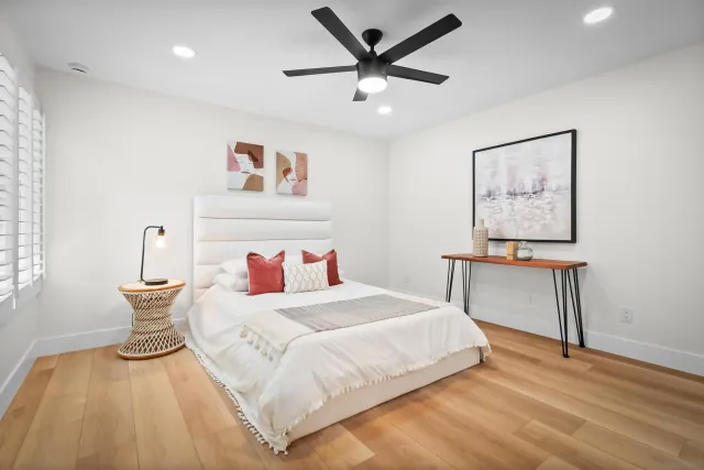 a bedroom with a large bed and a chandelier