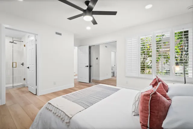 a bedroom with a bed and a window