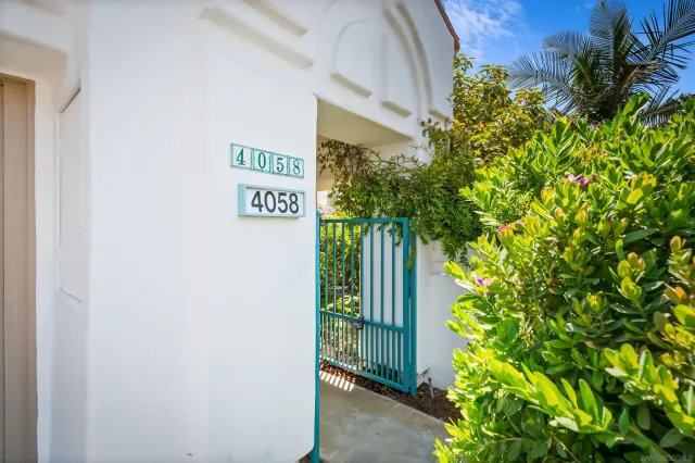 a view of sign board with plants