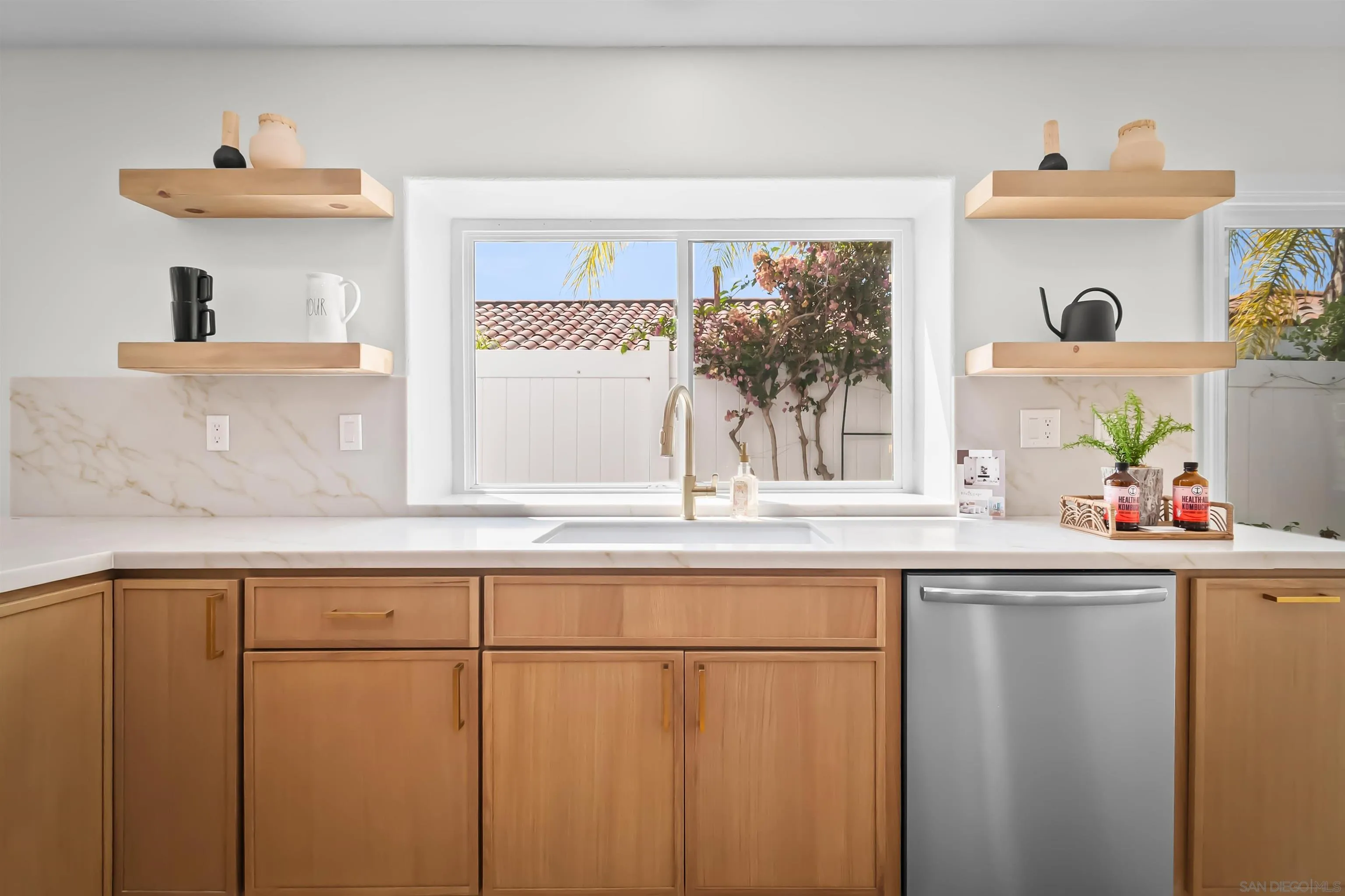 4058 Lemnos Way Oceanside, CA 92056 - Photo 6 of 47 a kitchen with a sink and cabinets