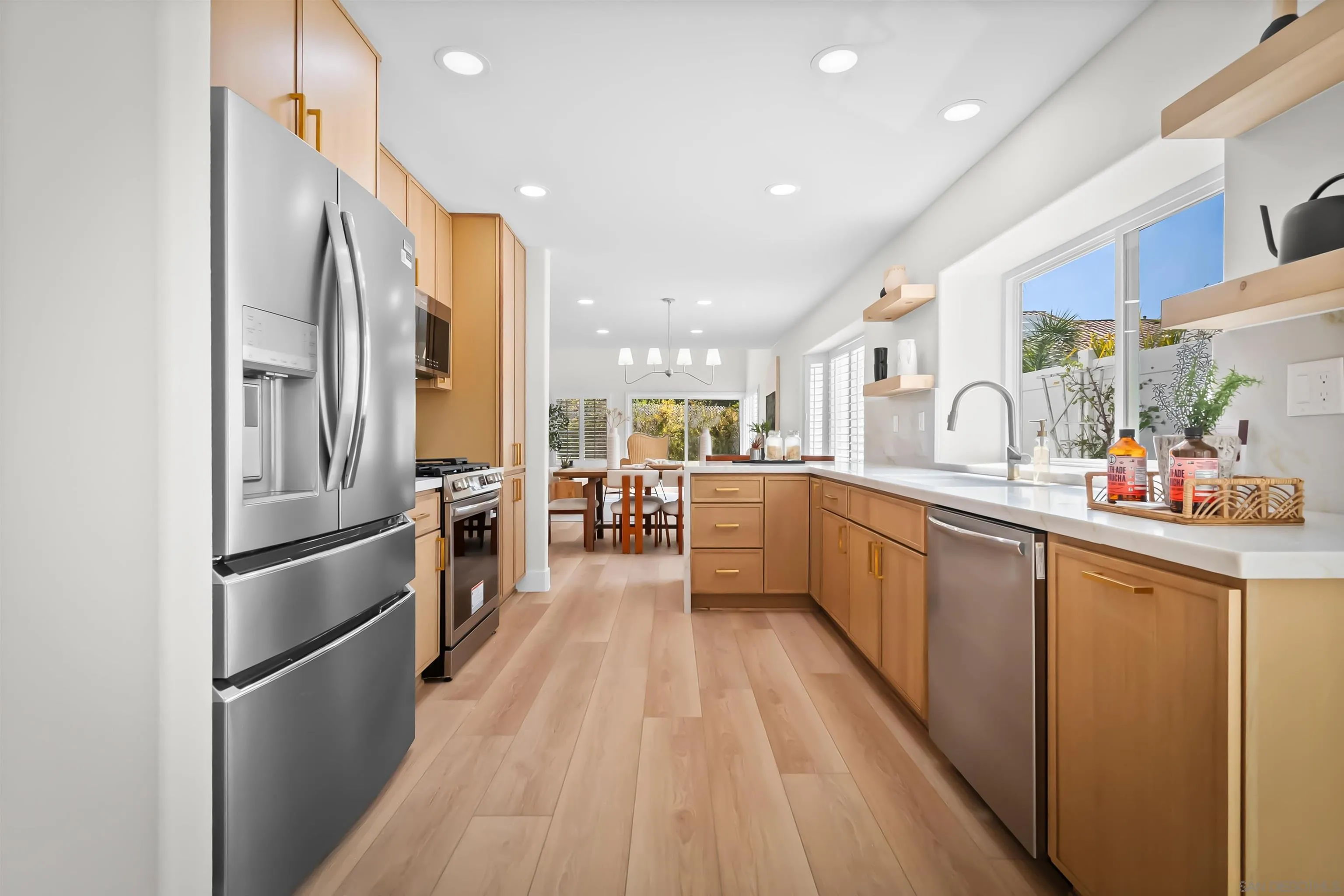 4058 Lemnos Way Oceanside, CA 92056 - Photo 8 of 47 a kitchen with stainless steel appliances a refrigerator and a sink