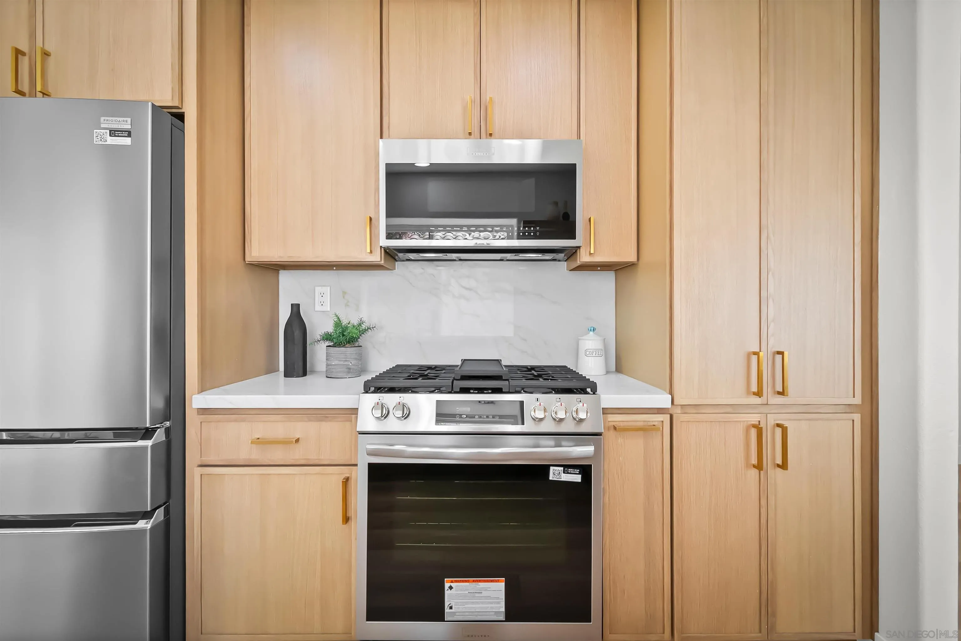 4058 Lemnos Way Oceanside, CA 92056 - Photo 9 of 47 a kitchen with a stove and a microwave