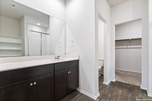a bathroom with a double vanity sink and mirror