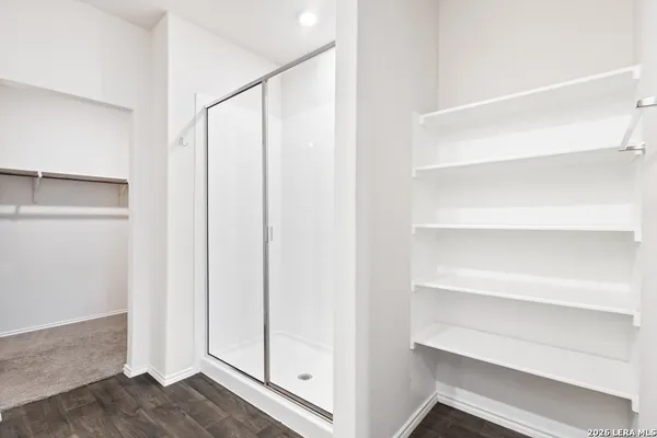 a view of walk in closet with empty racks