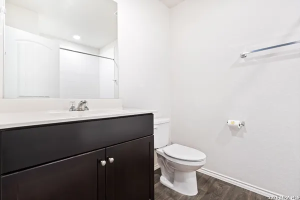 a bathroom with a sink a toilet and a mirror
