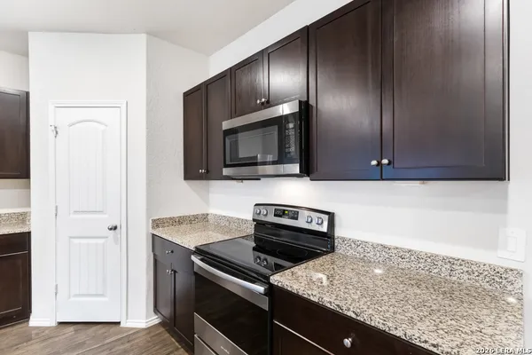 a kitchen with granite countertop stainless steel appliances and cabinets