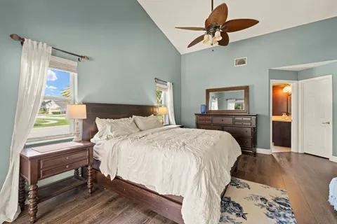 a bedroom with a bed and a chandelier