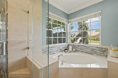 a bath tub sitting next to a window