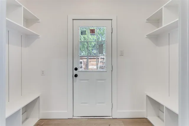 a view of an entryway with wooden floor
