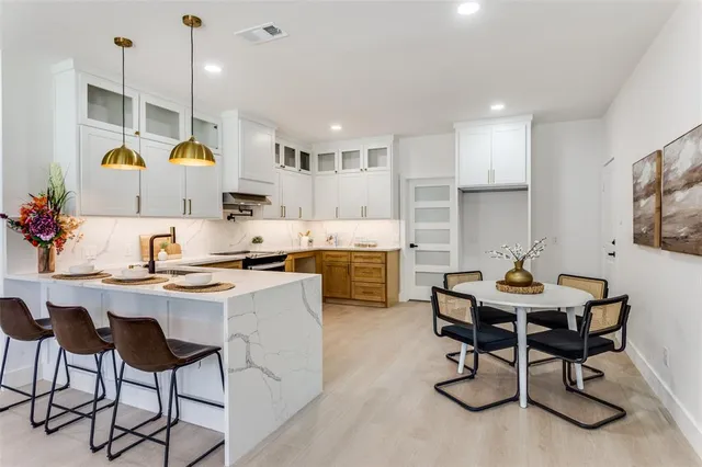 a living room with furniture and kitchen view