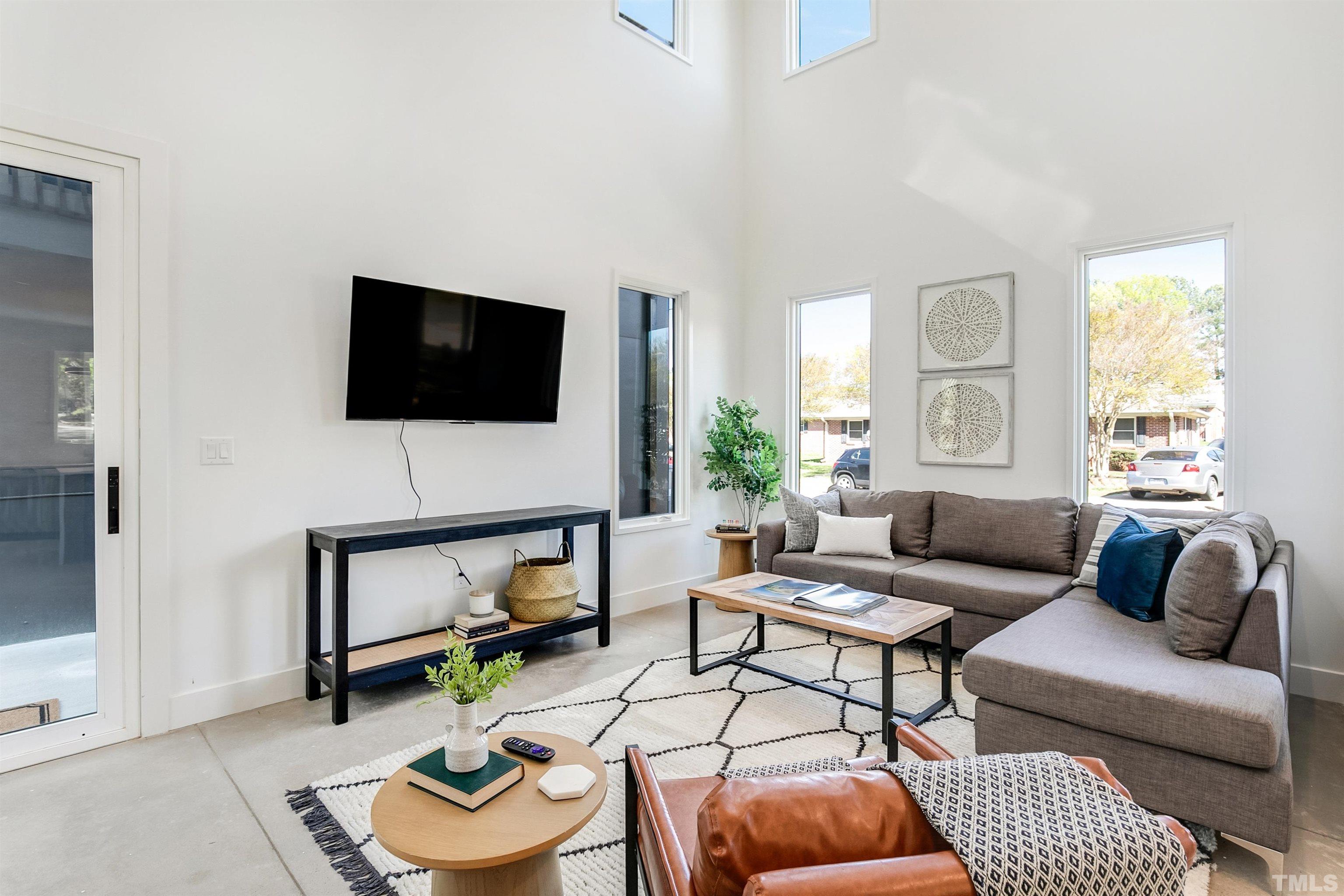 2159 Parker Street, Unit B Raleigh, NC 27607 - Photo 2 of 29 a living room with furniture and a flat screen tv