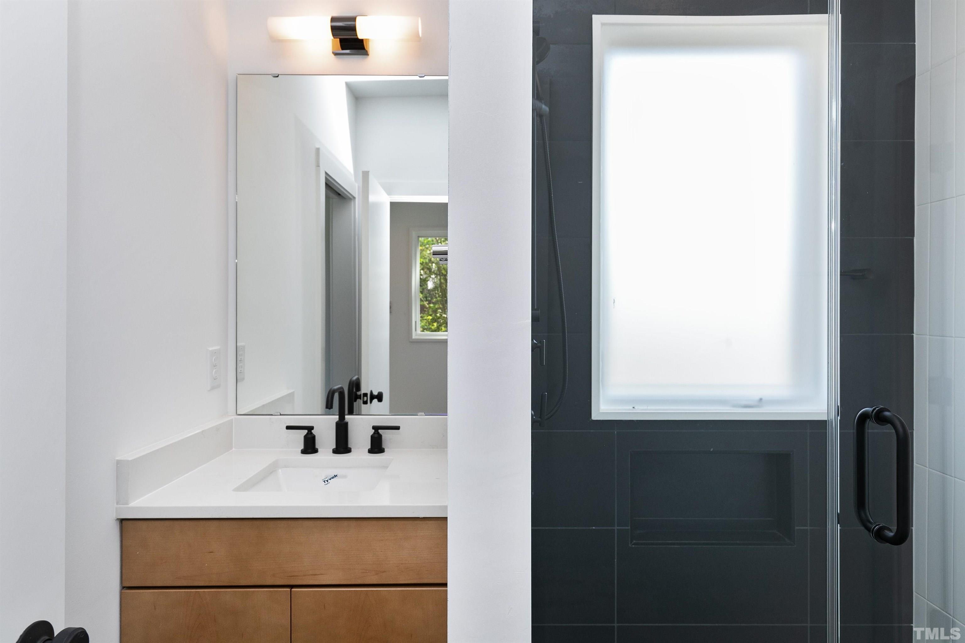2159 Parker Street, Unit B Raleigh, NC 27607 - Photo 25 of 29 a bathroom with a sink and a mirror