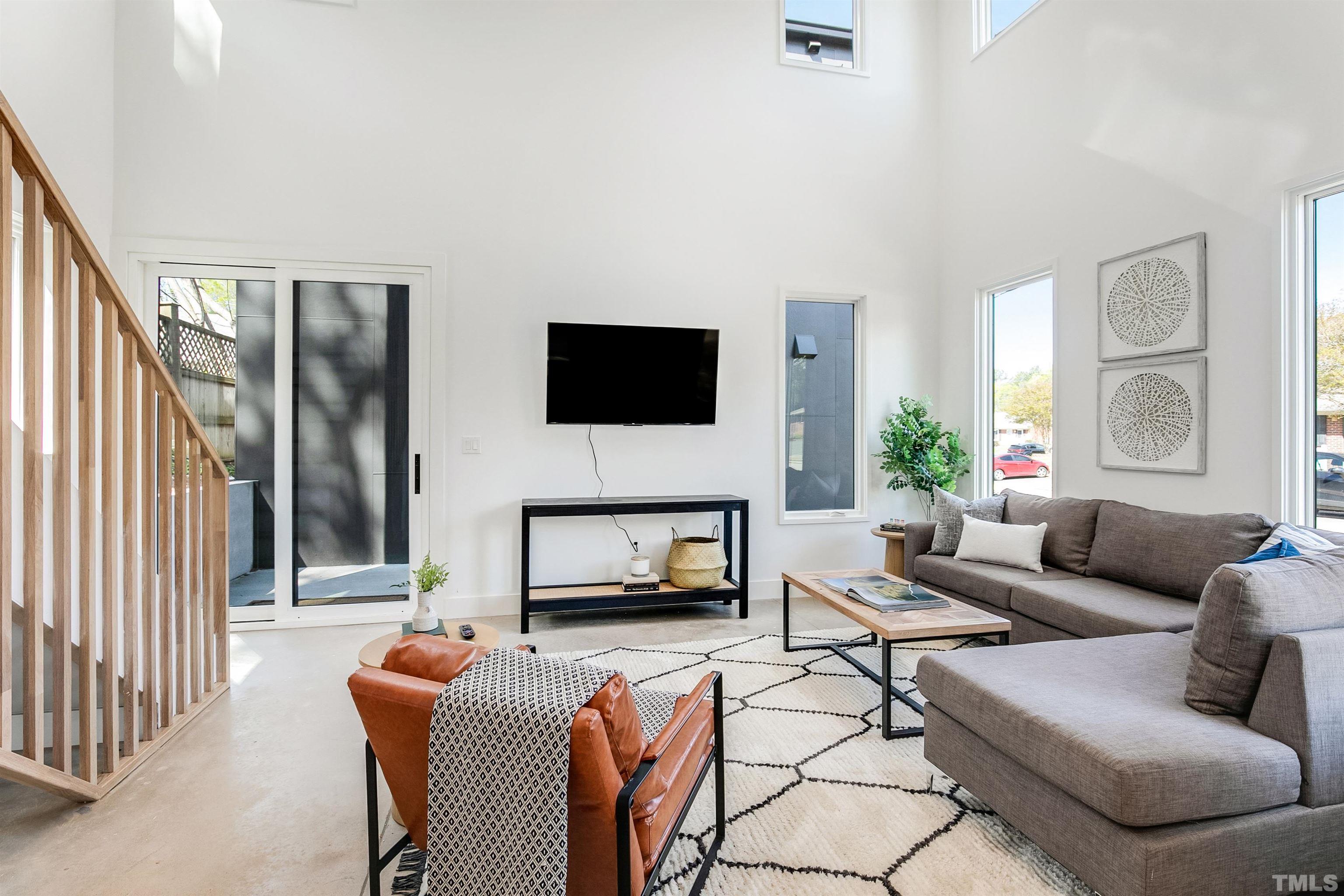 2159 Parker Street, Unit B Raleigh, NC 27607 - Photo 5 of 29 a living room with furniture and a flat screen tv