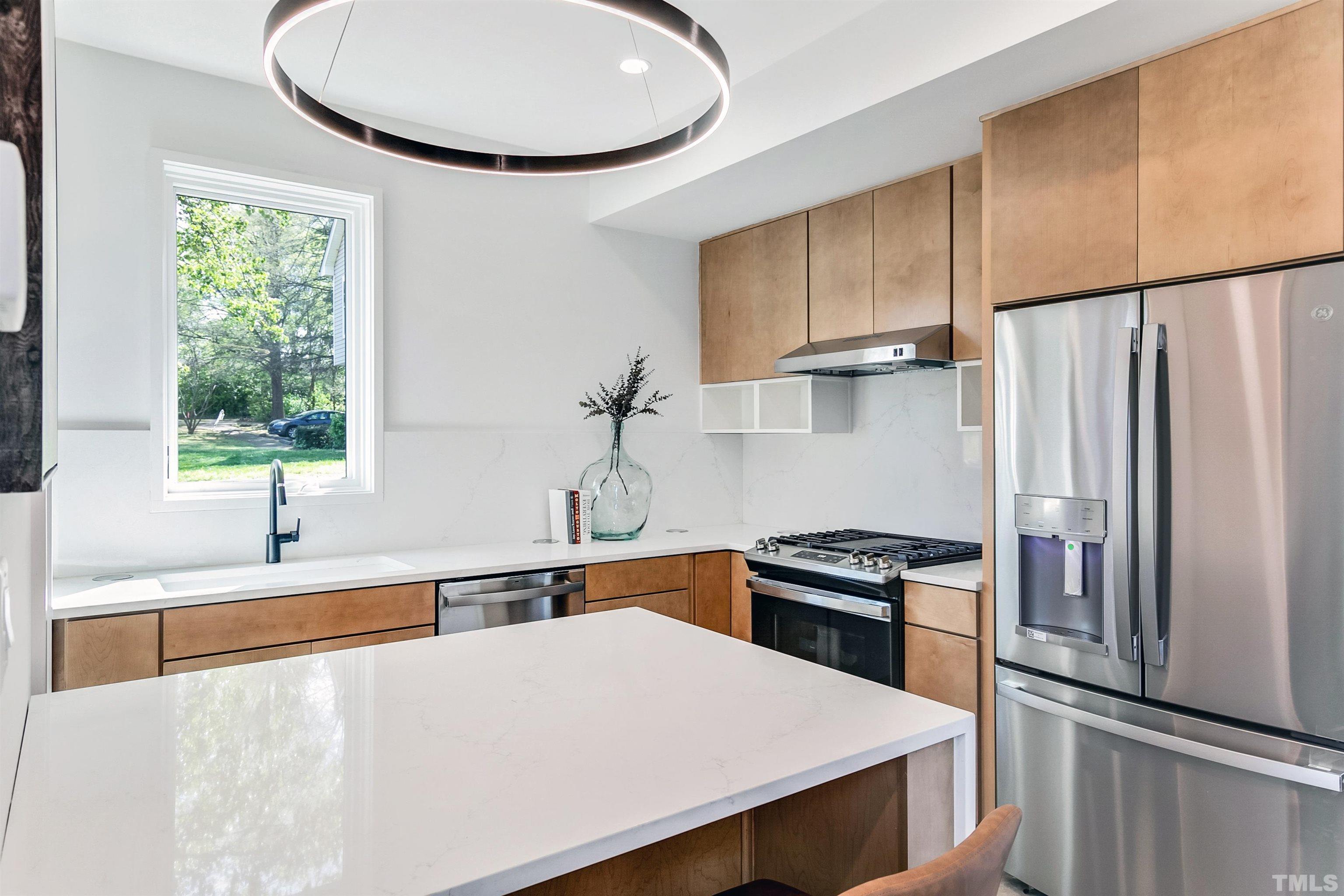 2159 Parker Street, Unit B Raleigh, NC 27607 - Photo 10 of 29 a kitchen with a refrigerator and a sink