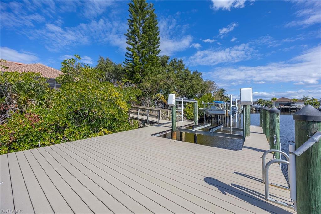 146 Windward Cay Naples, FL 34114 - Photo 30 of 33 a view of a patio with chairs and potted plants
