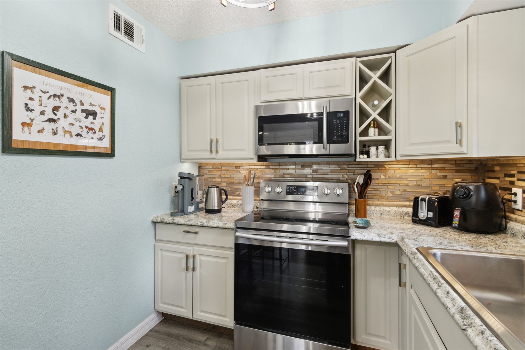 97471 Cutlass Way Yulee, FL 32097 - Photo 11 of 56 a kitchen with a stove and a microwave