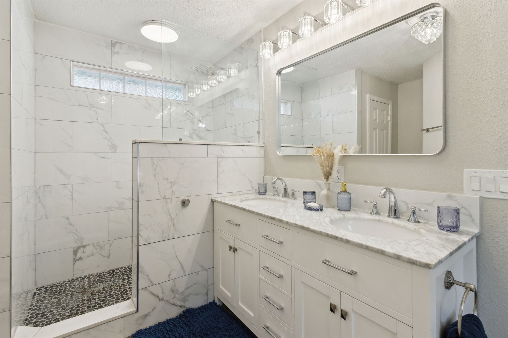 97471 Cutlass Way Yulee, FL 32097 - Photo 16 of 56 a bathroom with a double vanity sink mirror and shower