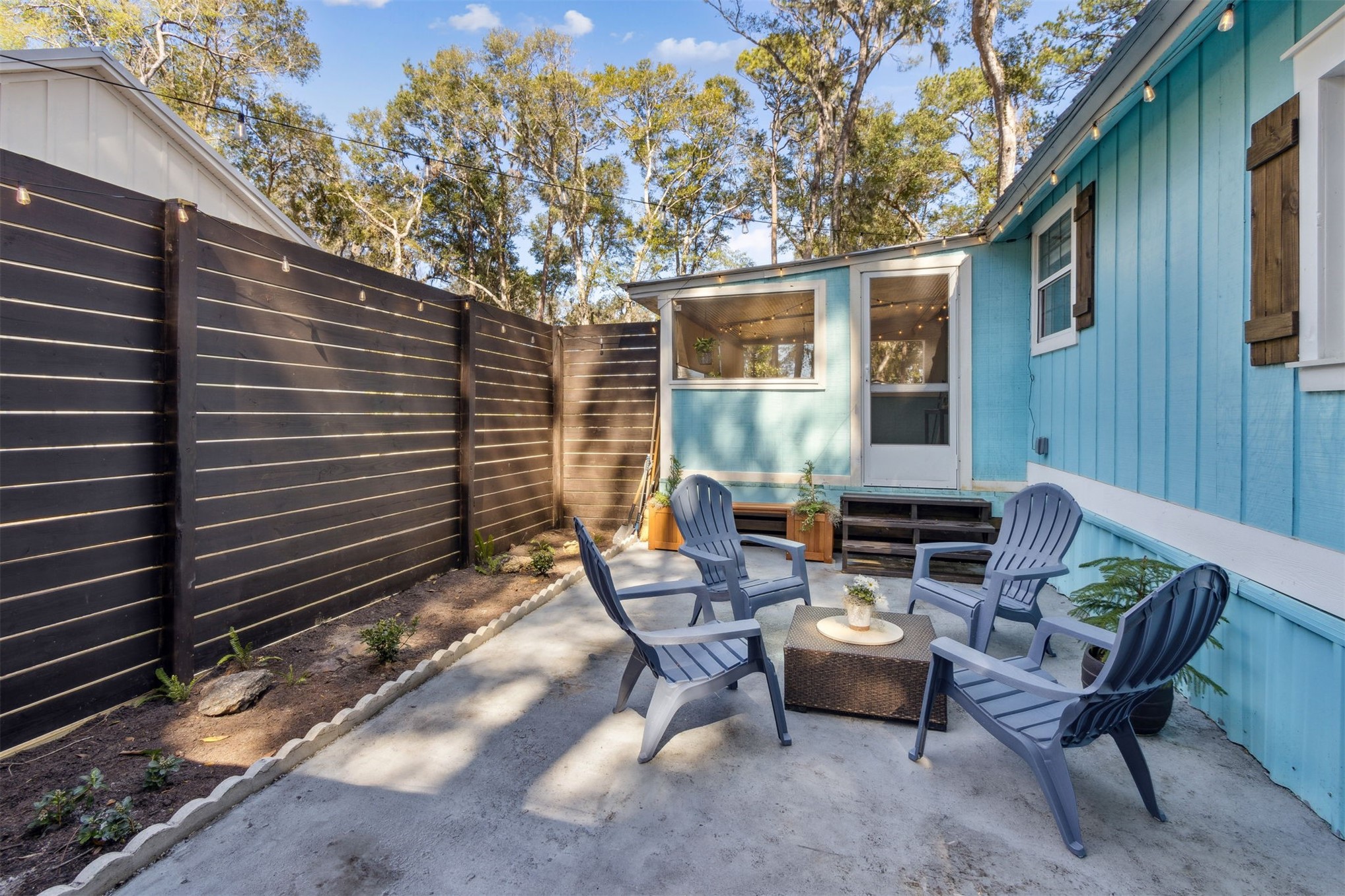97471 Cutlass Way Yulee, FL 32097 - Photo 30 of 56 a backyard of a house with outdoor seating