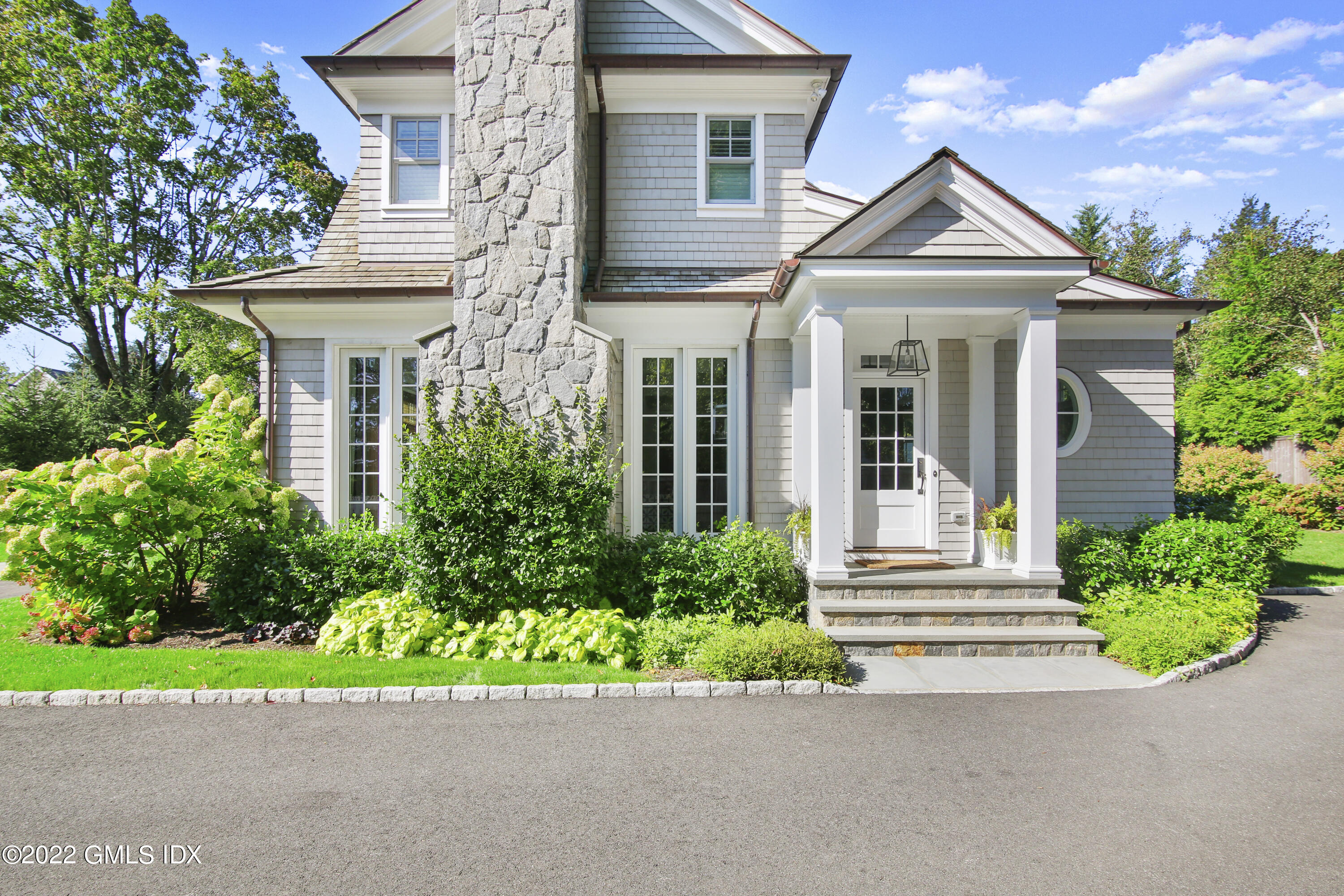 249 Riverside Avenue Riverside, CT 06878 - Photo 44 of 56 a front view of a house with a yard and potted plants