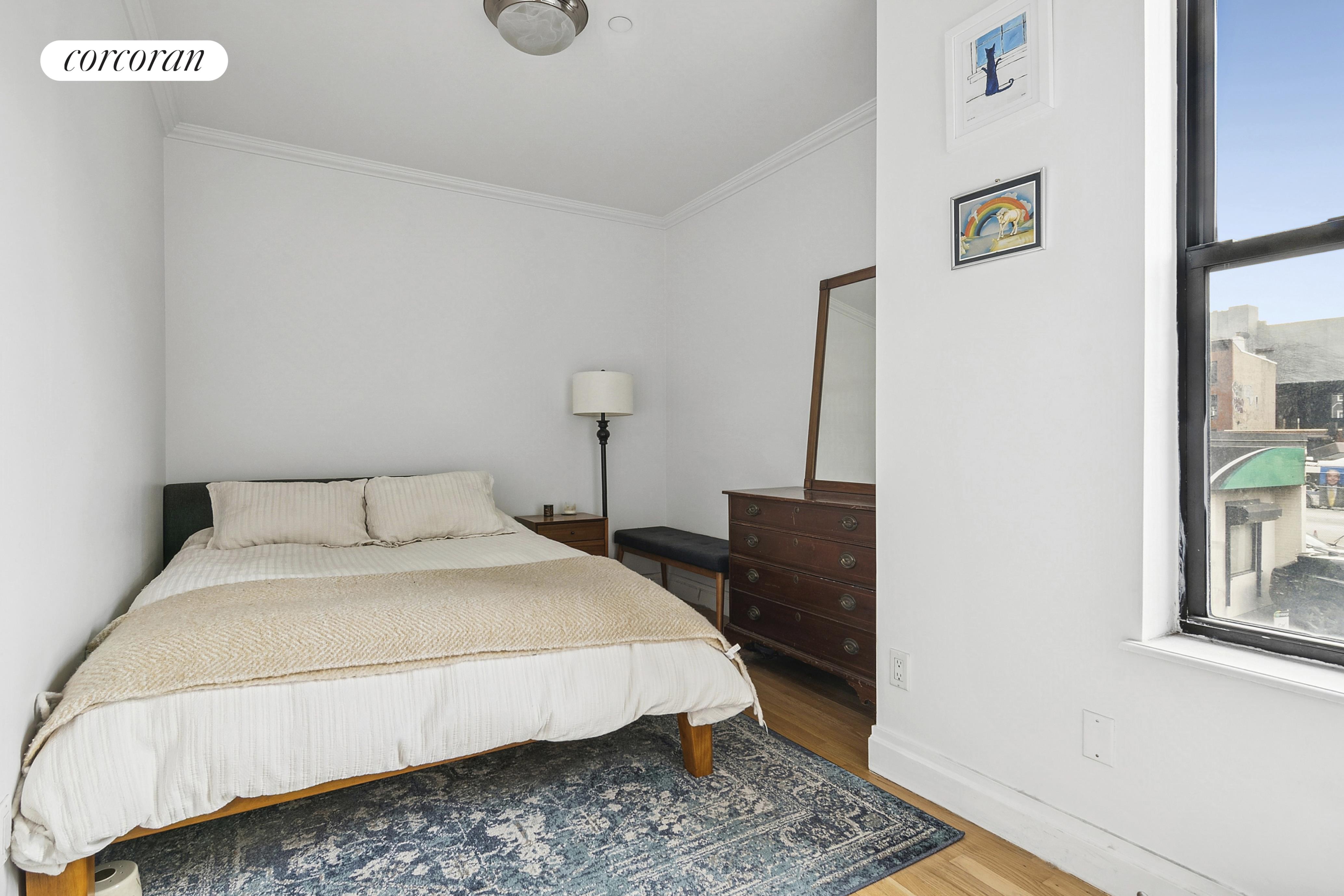 445 3rd Avenue, Unit 202 Brooklyn, NY 11215 - Photo 4 of 6 a bedroom with a bed and wooden floor