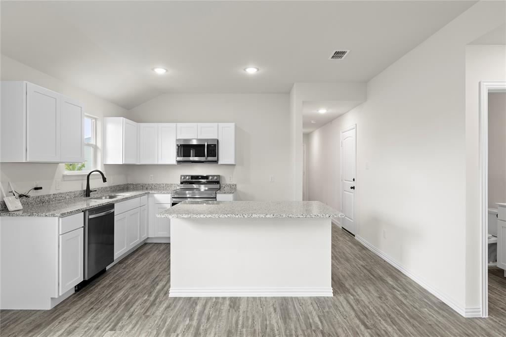 114 Goel Street Greenville, TX 75402 - Photo 14 of 32 a kitchen with a sink stove and cabinets