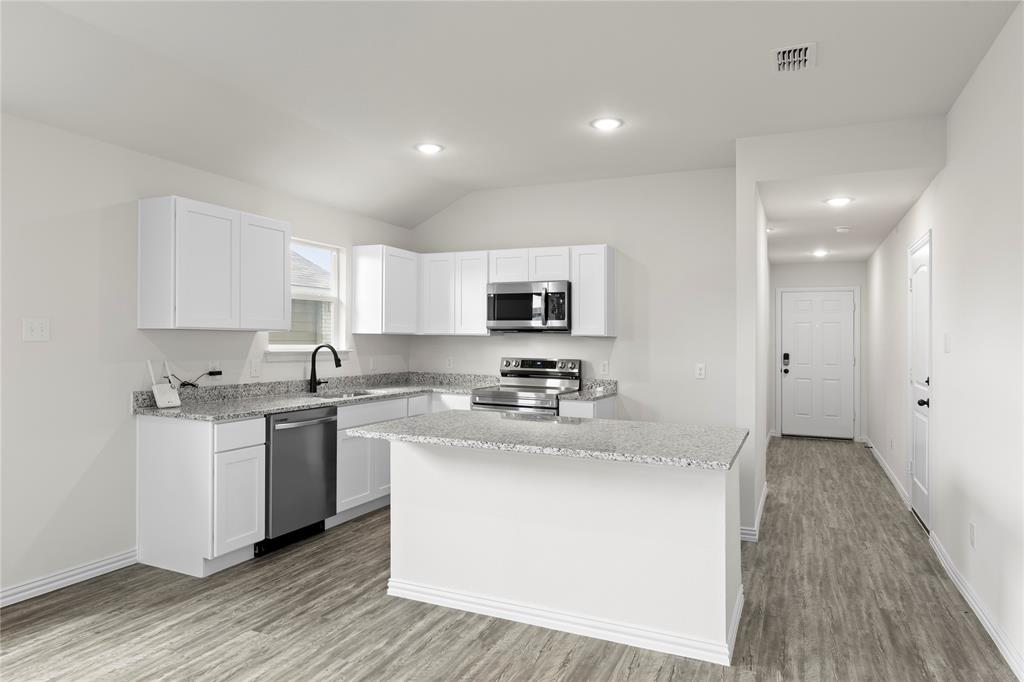 114 Goel Street Greenville, TX 75402 - Photo 16 of 32 a kitchen with stainless steel appliances granite countertop a sink stove and cabinets