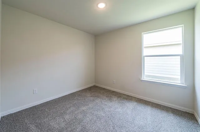 a kitchen with white cabinets appliances and a sink