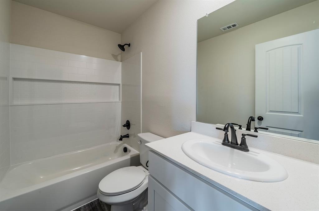 114 Goel Street Greenville, TX 75402 - Photo 21 of 32 a bathroom with a sink toilet and shower