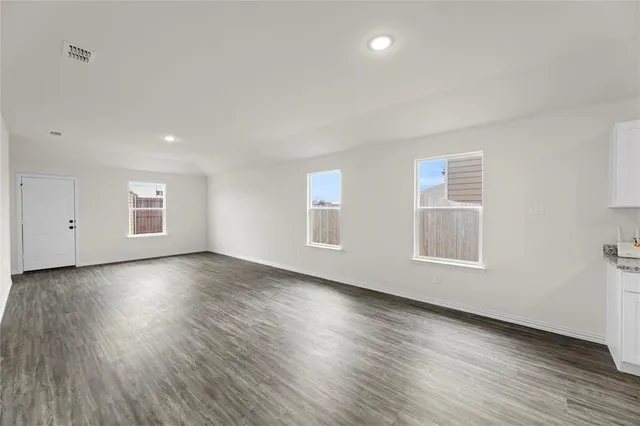 a view of kitchen with wooden floor and stainless steel appliances