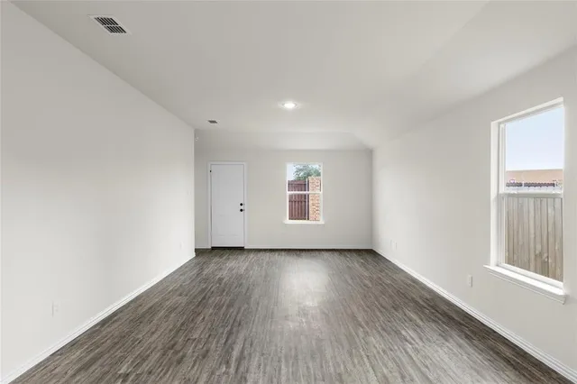 a view of a room with wooden floor and window