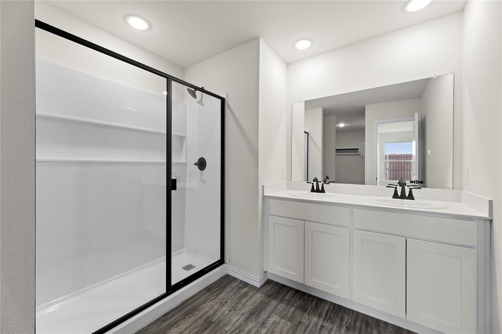 114 Goel Street Greenville, TX 75402 - Photo 29 of 32 a bathroom with a double vanity sink and mirror