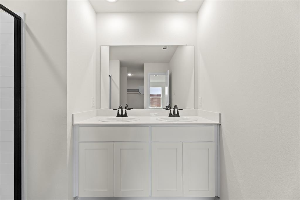 114 Goel Street Greenville, TX 75402 - Photo 30 of 32 a bathroom with a sink and a mirror