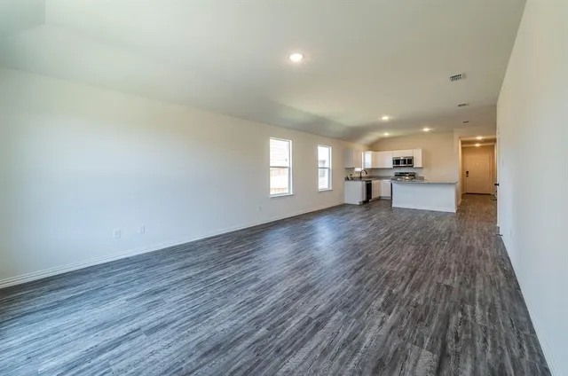 a view of a room with wooden floor and furniture
