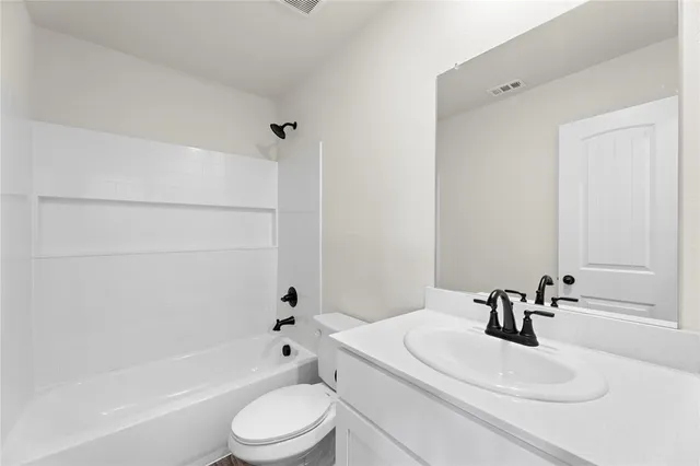 a kitchen with stainless steel appliances granite countertop a sink a stove a refrigerator and cabinets