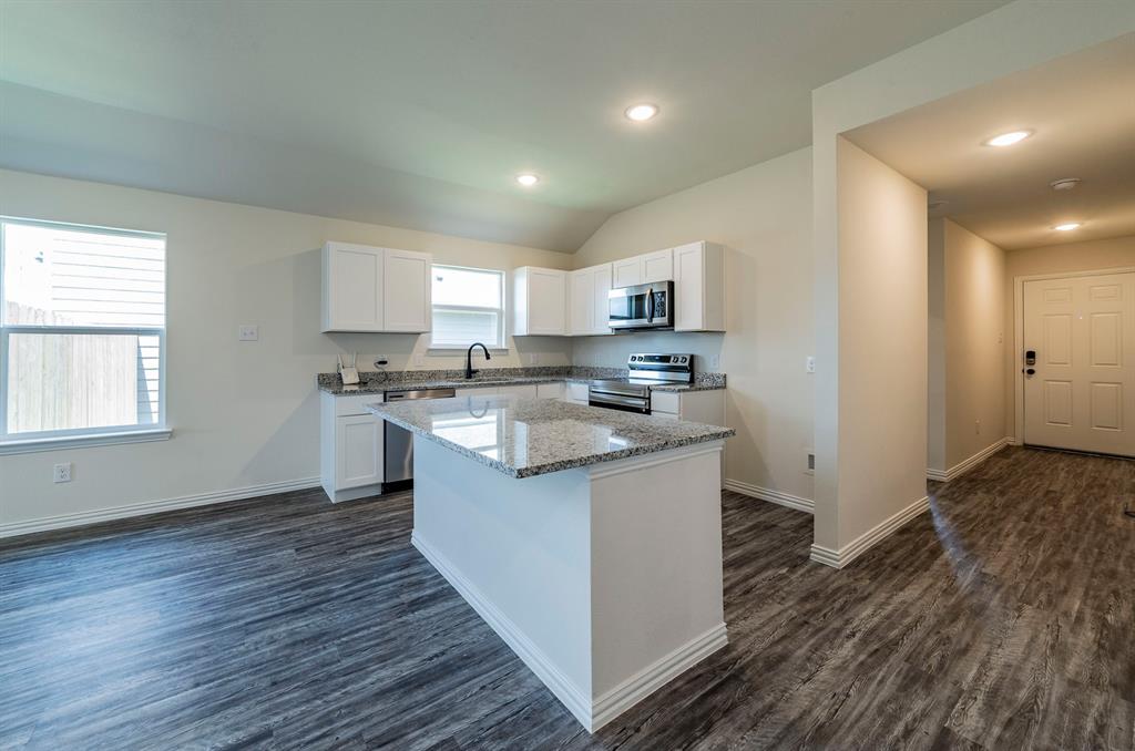 114 Goel Street Greenville, TX 75402 - Photo 7 of 32 a kitchen with stainless steel appliances granite countertop a sink a stove a refrigerator and cabinets