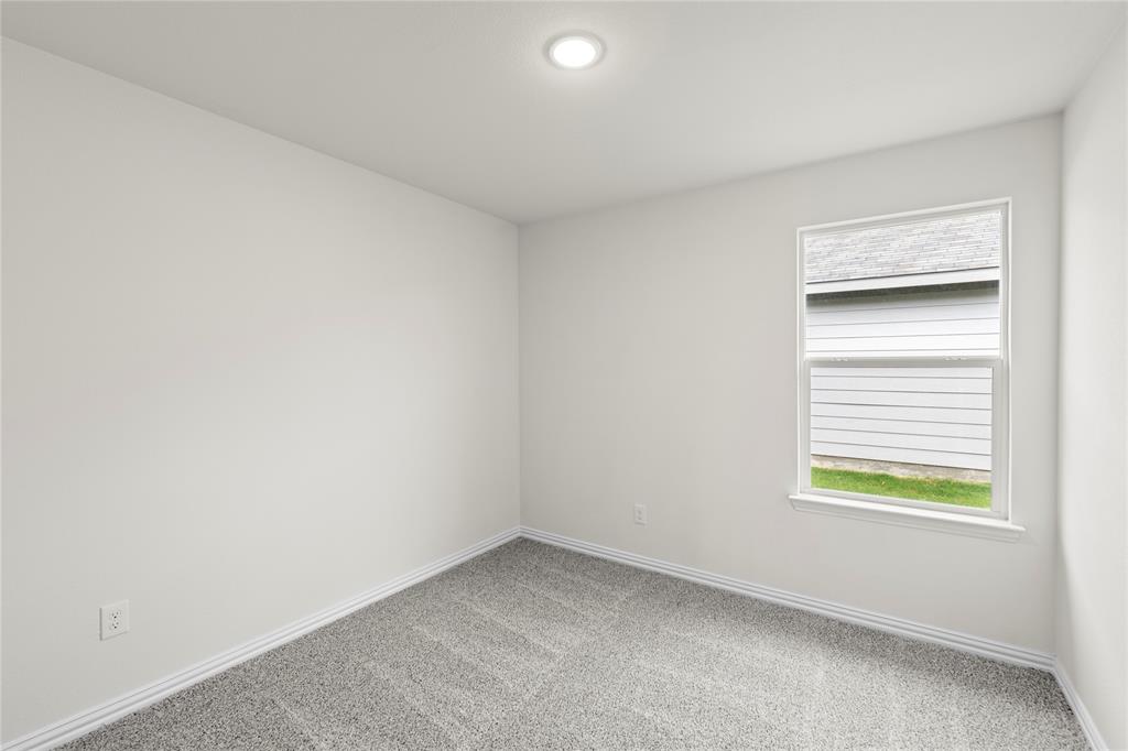 114 Goel Street Greenville, TX 75402 - Photo 8 of 32 a view of an empty room with a window