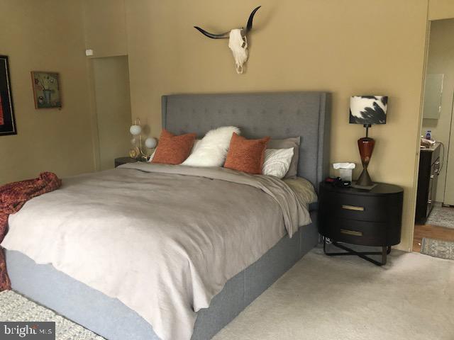 2118 Welsh Valley Road Phoenixville, PA 19460 - Photo 21 of 37 a large bed sitting in a bedroom next to a lamp