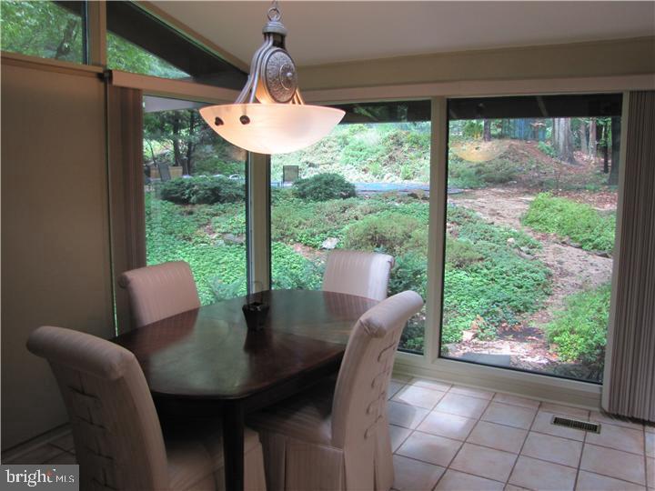 2118 Welsh Valley Road Phoenixville, PA 19460 - Photo 9 of 37 a dining room with furniture and a floor to ceiling window