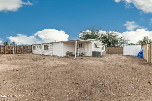 a view of a white house with a yard