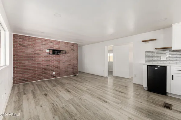 wooden floor in an empty room with a fireplace