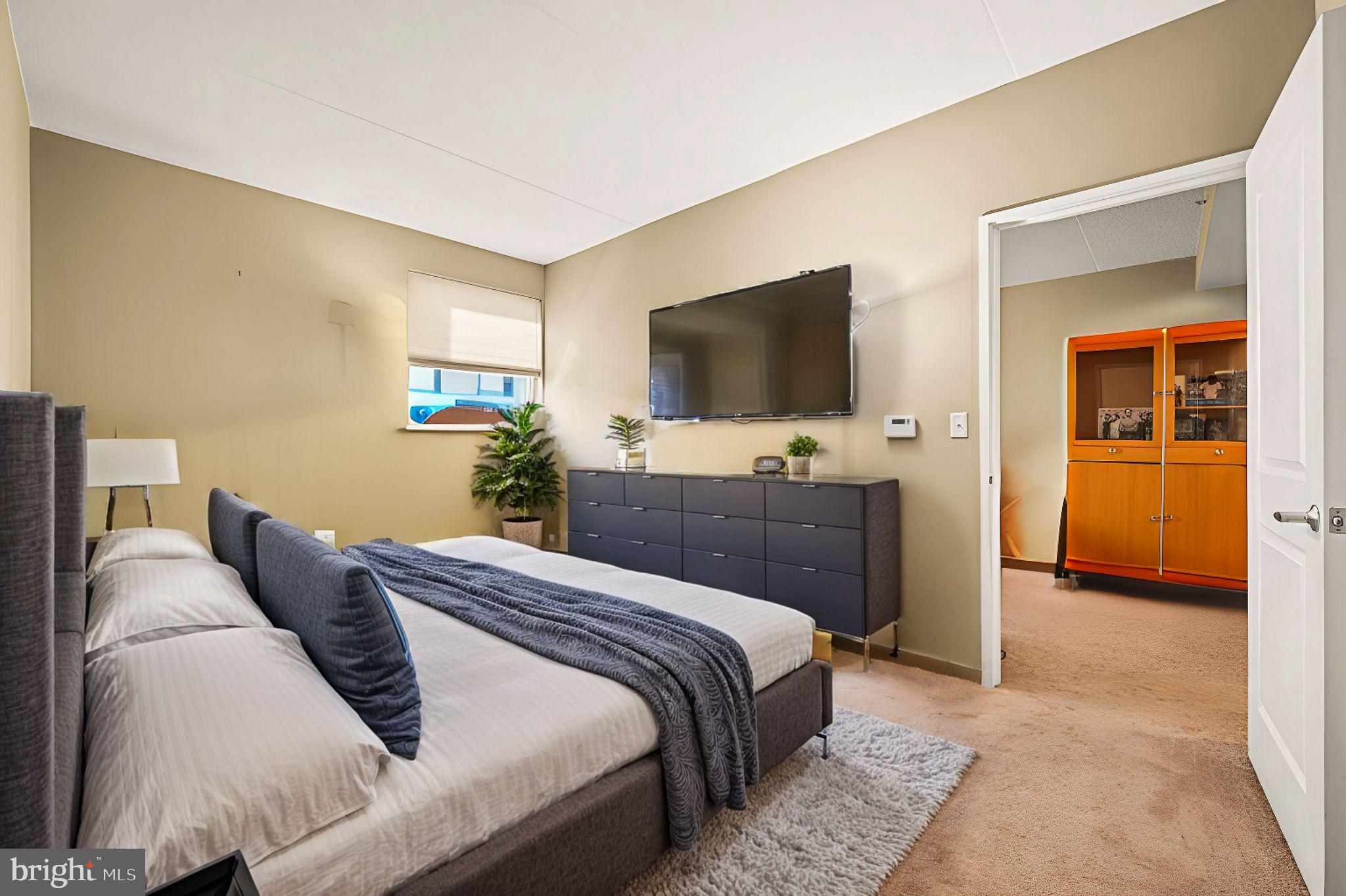 815 Arch Street, Unit 519 Philadelphia, PA 19107 - Photo 13 of 13 a bedroom with a bed and a flat screen television