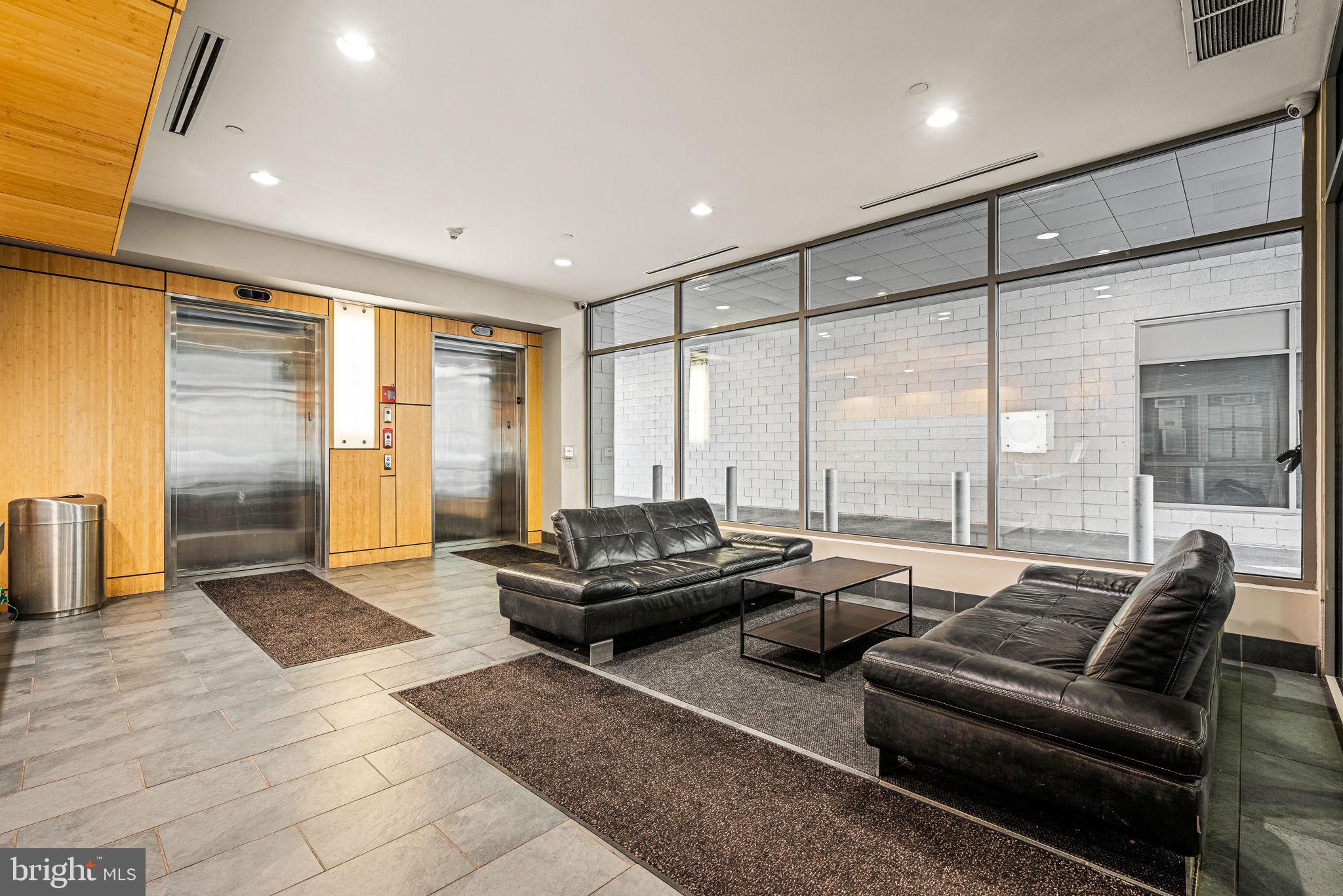 815 Arch Street, Unit 519 Philadelphia, PA 19107 - Photo 5 of 13 a living room with furniture and large windows