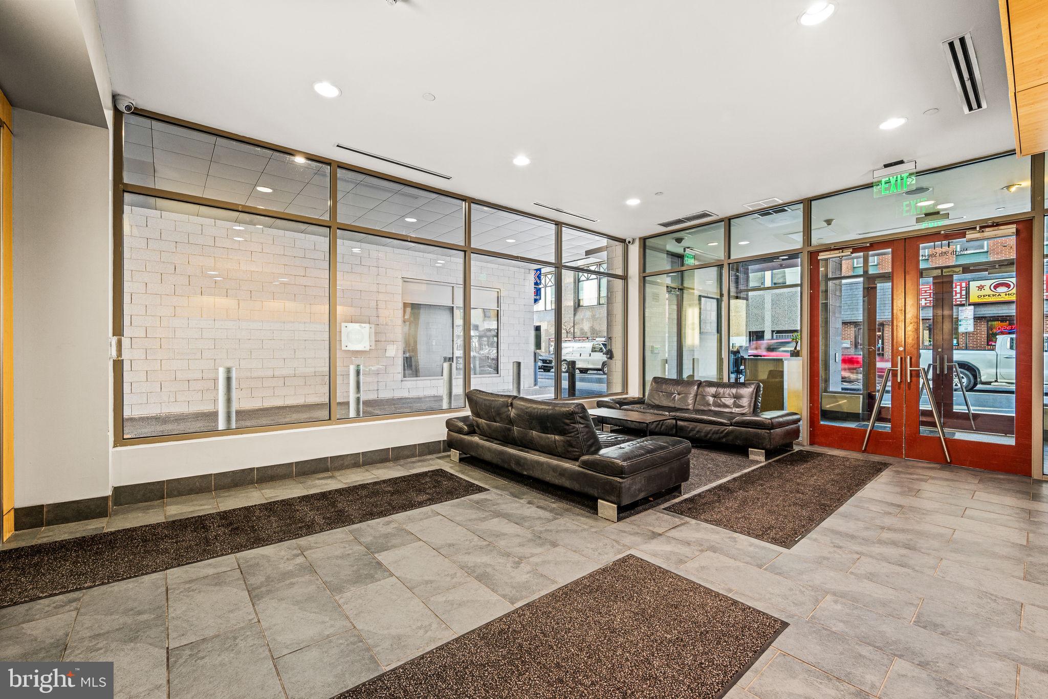 815 Arch Street, Unit 519 Philadelphia, PA 19107 - Photo 8 of 13 a living room with furniture and a large window