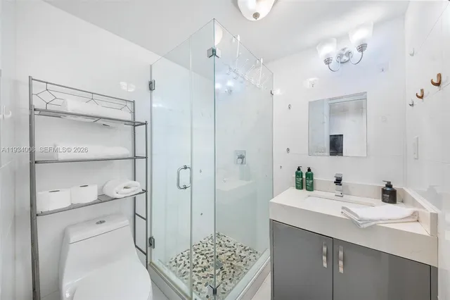 a spacious bathroom with a sink a toilet and shower